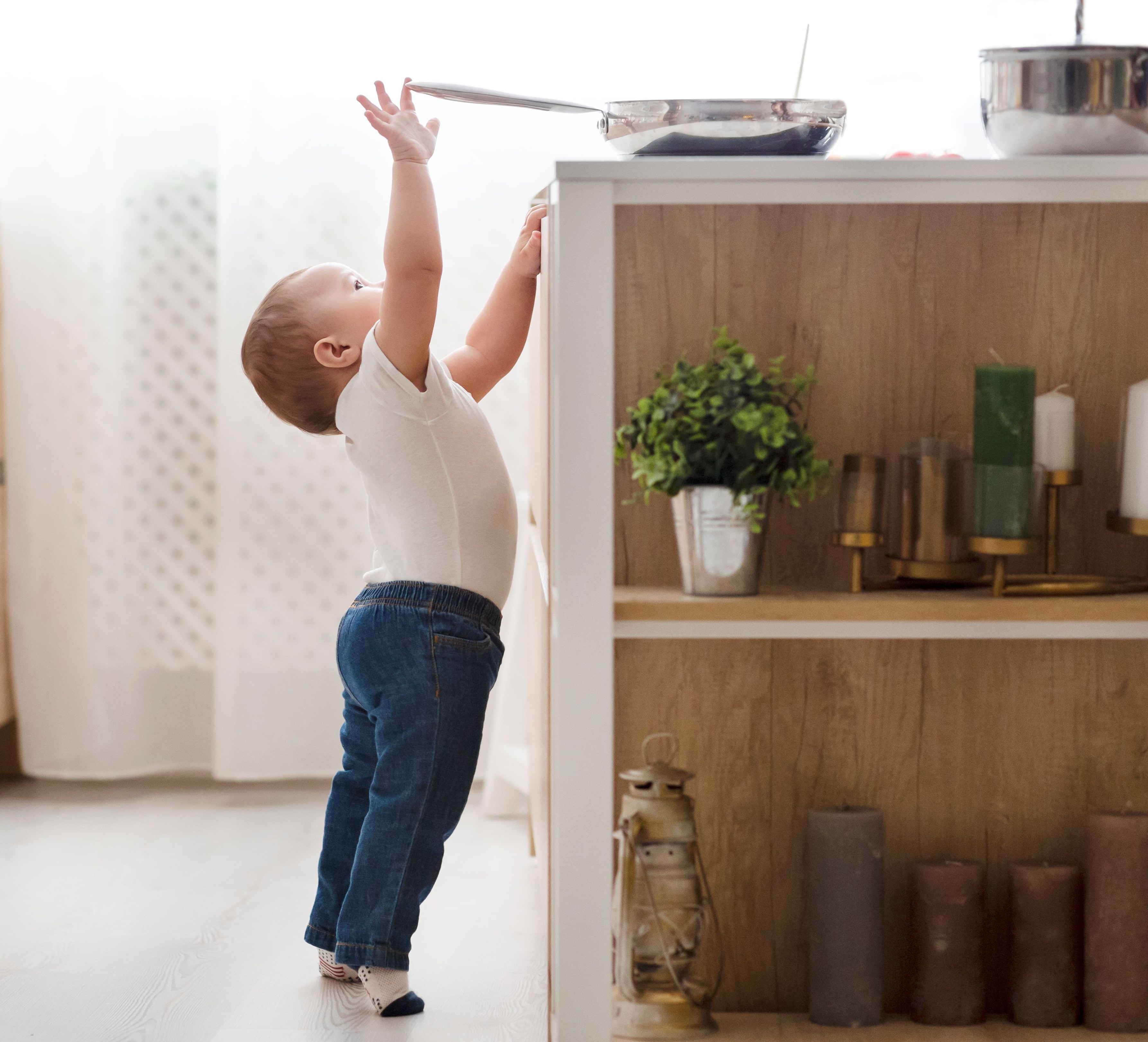 A child may pull a hot pan from the stove, but the outcome is uncertain.