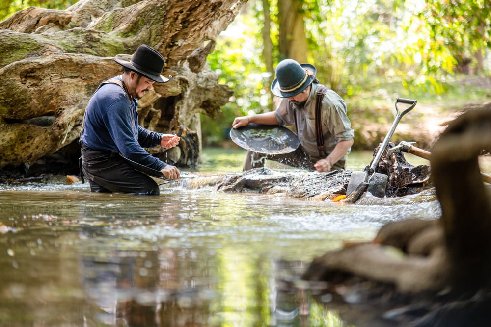 A group of miners are prospecting for gold and new clients.